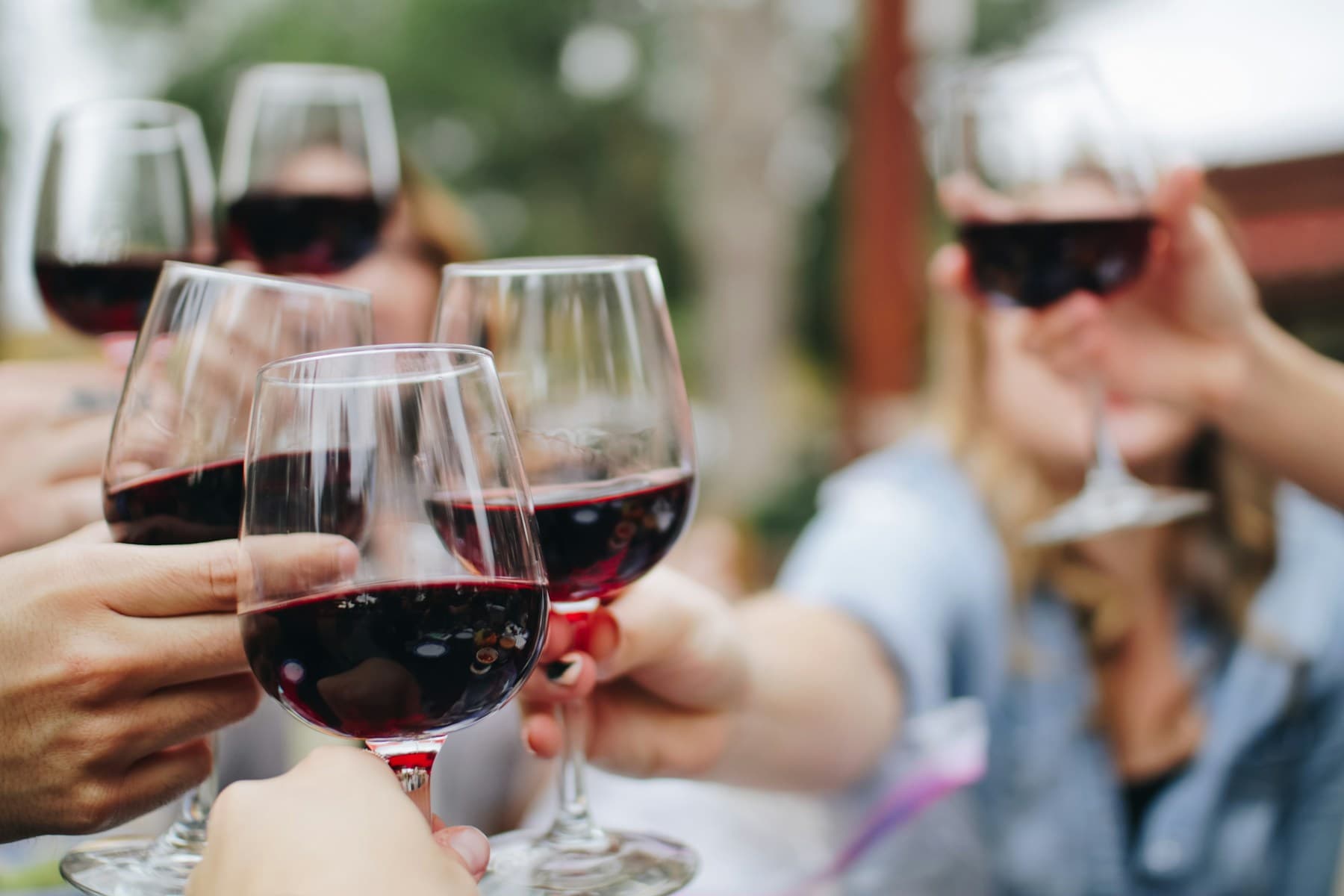 Friends raising glasses of wine together